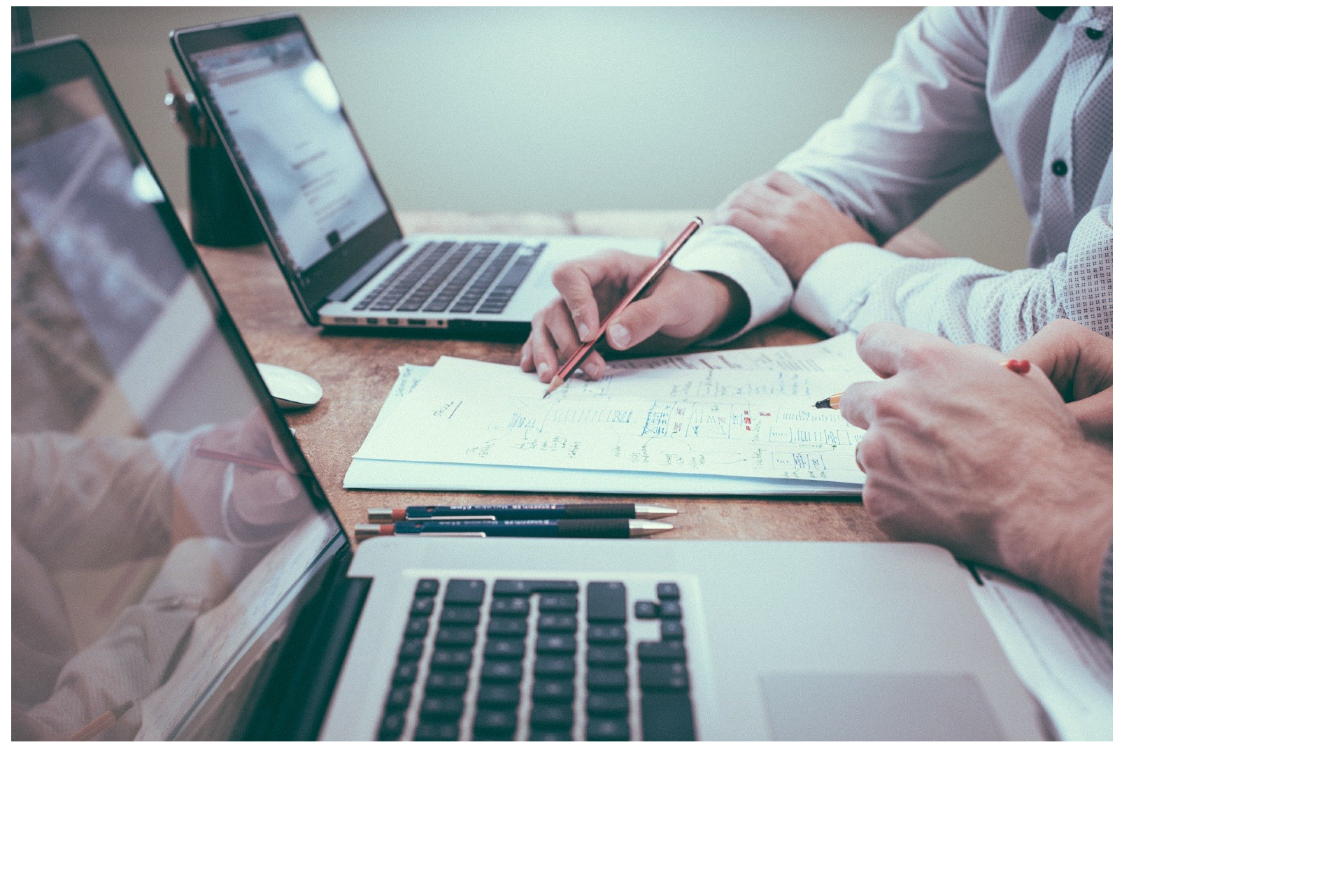 Two people working at laptops.