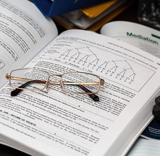 Glasses on an open text book.